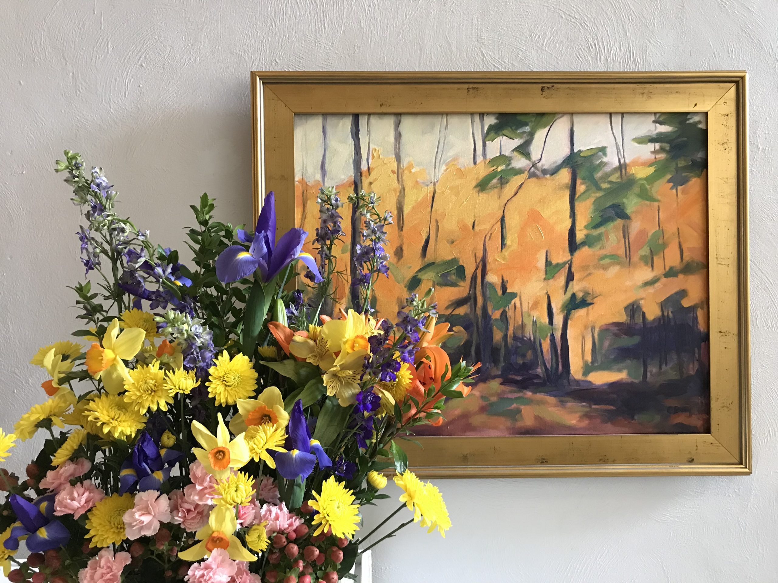 Flower arrangement next to painting